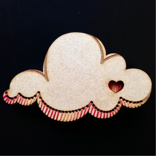 A wooden cloud with embroidery
